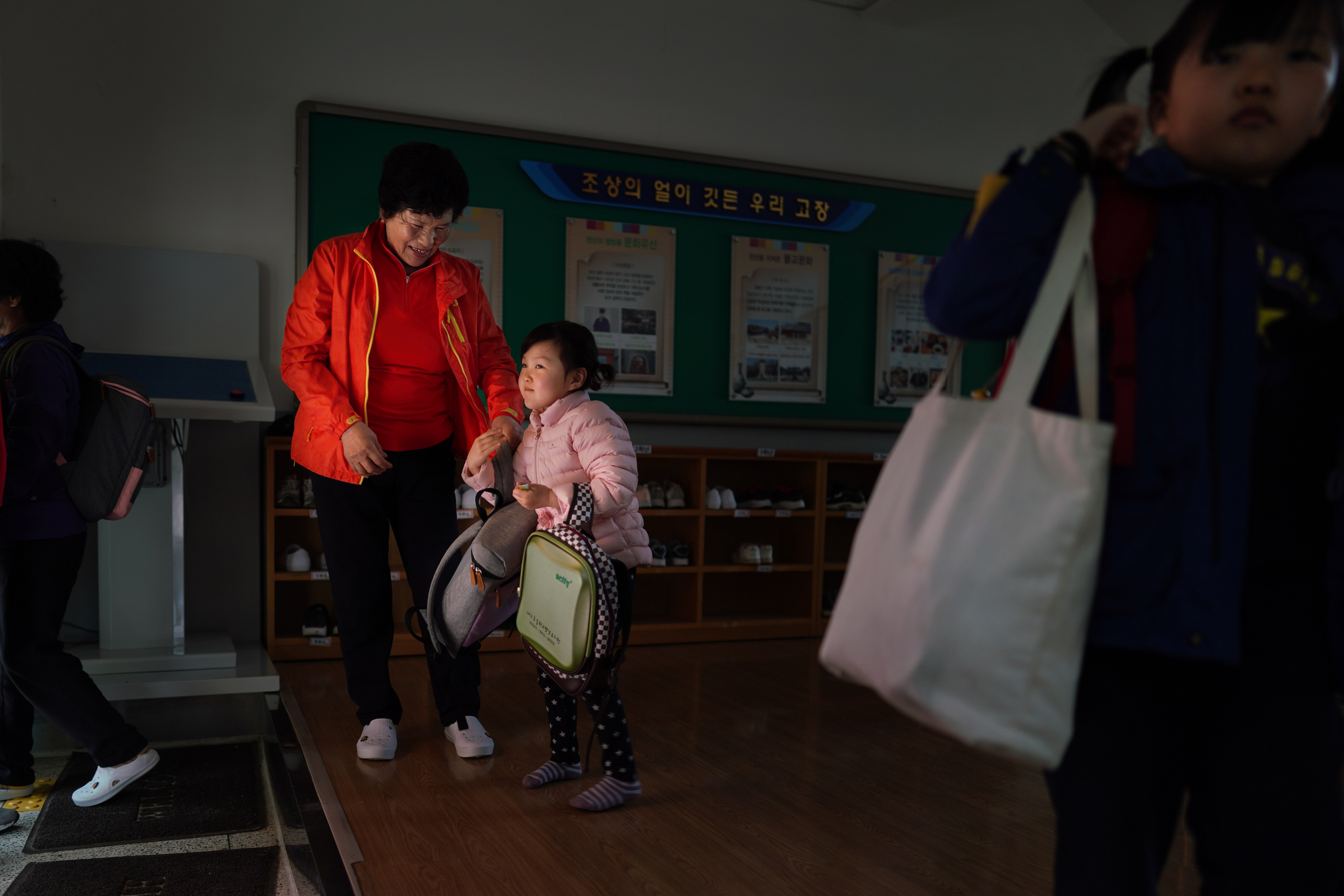 Hwang Wol-geum, 70, and her granddaughter, Soo-hee, arrive for classes. Hwang Wol-geum, 70, and her granddaughter, Soo-hee, arrive for classes at Daegu Elementary, in Gangjin County, South Korea.