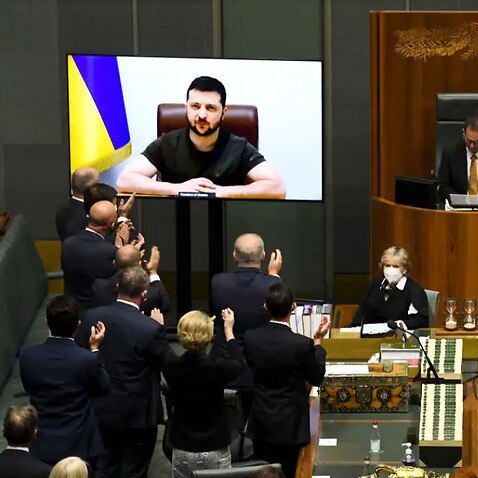 Australian members of Parliament applaude as Ukrainian President Volodymyr Zelenskiy addresses the House of Representatives via a video link at Parliament House in Canberra, Thursday, March 31, 2022. 