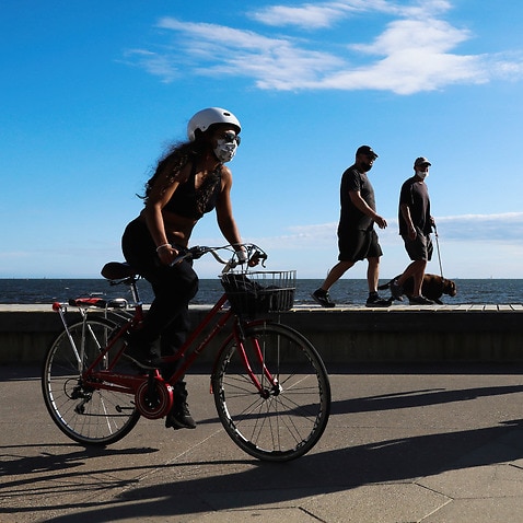 People walking and cycling along the St Kilda Beach Promenade in Melbourne, 28 October, 2020. 