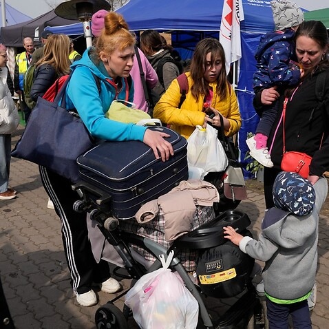 Refugee Olga, left, with her children departs to Pokrovsk, Donetsk Region, Ukraine from the border crossing in Medyka, southeastern Poland, on Wednesday, March 30, 2022. Following Russia's announcement that troops might be withdrawn from various parts of 