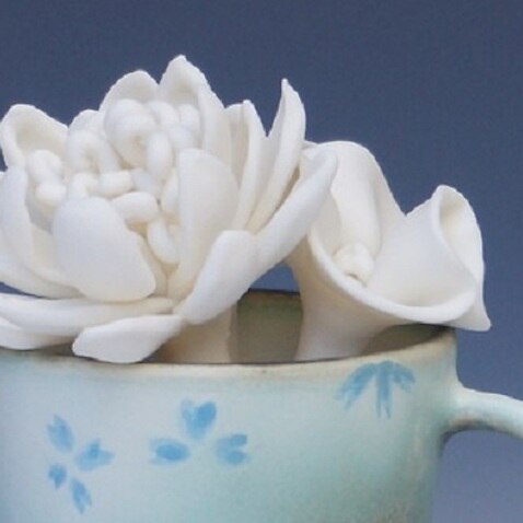 a piece of ceramic flowers artwork produced by Kit Wu.
