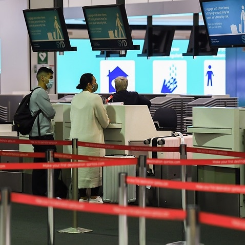 Passengers check in at Sydney airport