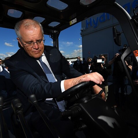 Prime Minister Scott Morrison observes a hydrogen powered forklift during a tour of the Toyota Hydrogen Centre in Altona, Melbourne, Tuesday, November 9, 2021. (AAP Image/James Ross) NO ARCHIVING