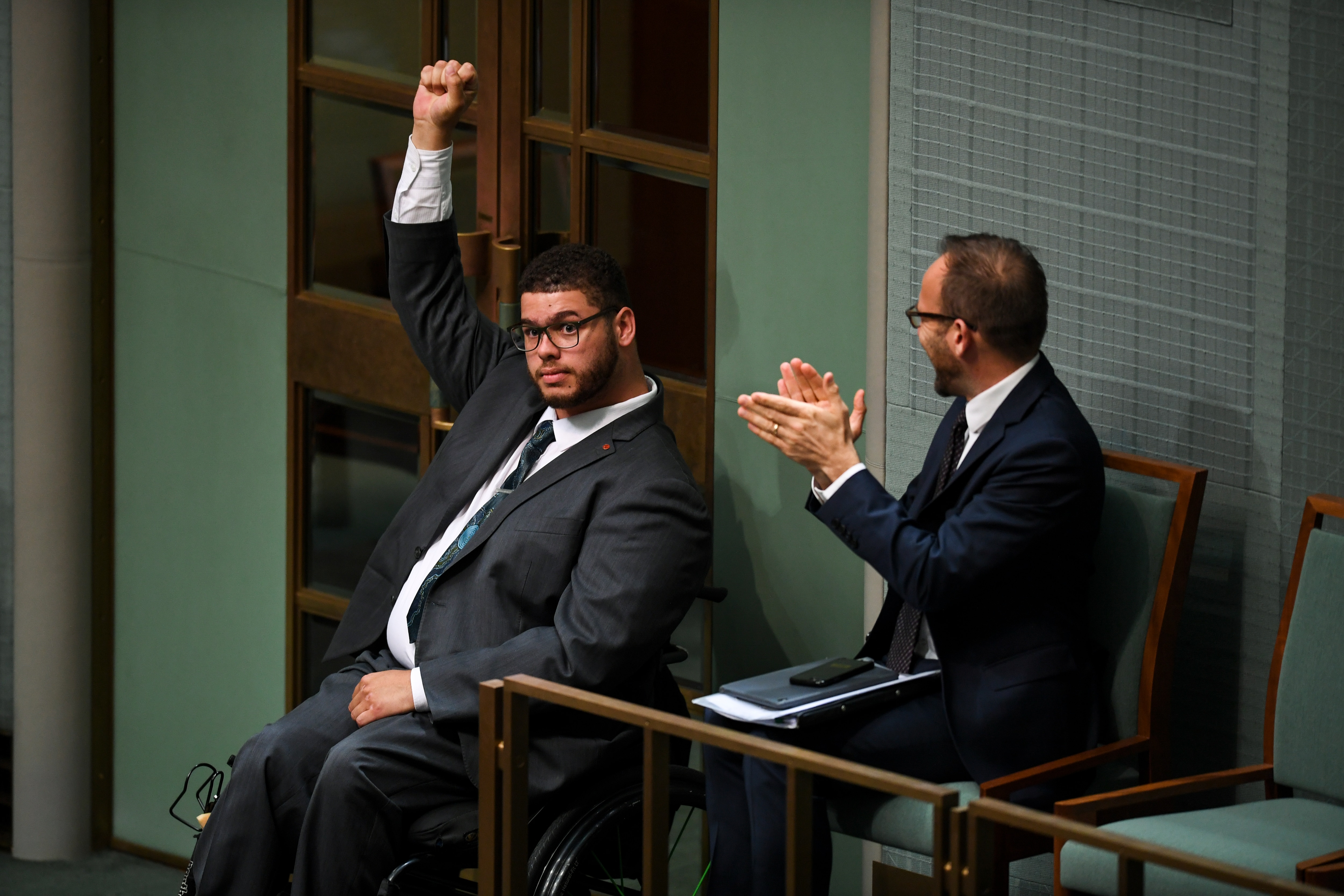 Greens Senator Jordon Steele-John celebrates after the passing of the motion on the Disability Abuse Royal Commission.