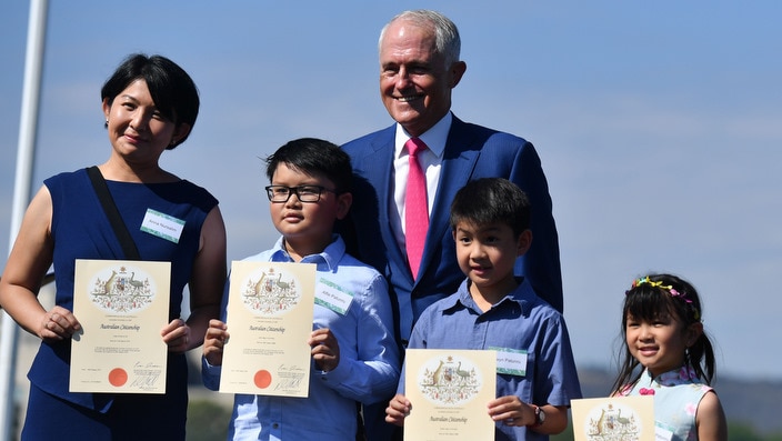 Prime Minister Malcolm Turnbull poses with new Australian citizens in Canberra
