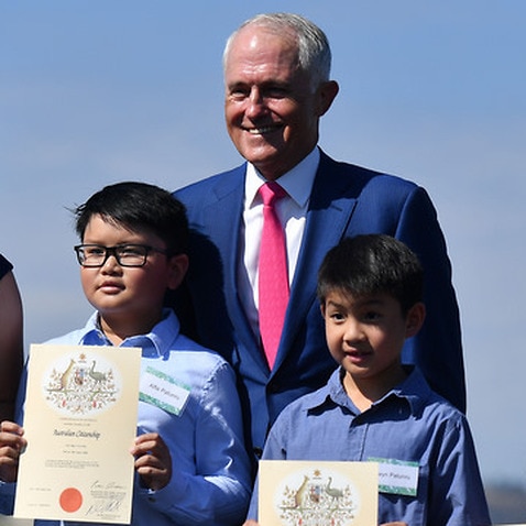 Prime Minister Malcolm Turnbull poses with new Australian citizens in Canberra