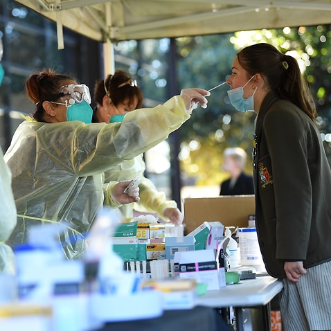 A Firbank Grammar student receives a COVID-19 Rapid Antigen test on campus in Brighton, Melbourne, 14 October, 2021. 