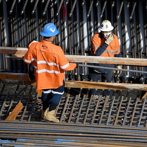 Construction workers are seen at the Barangaroo development site in Sydney on 19 August 2021.