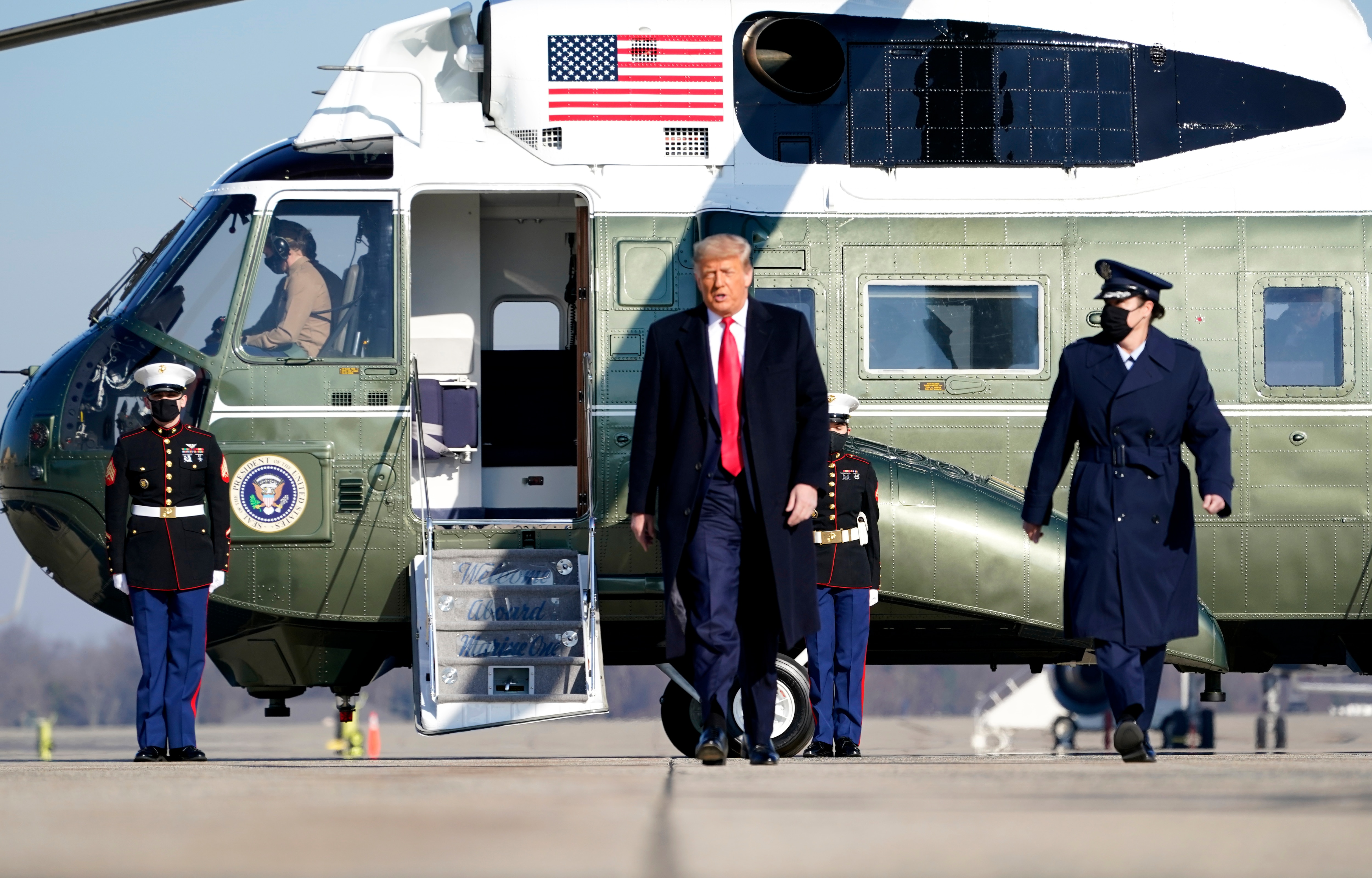 President Donald Trump walks to board Air Force One.