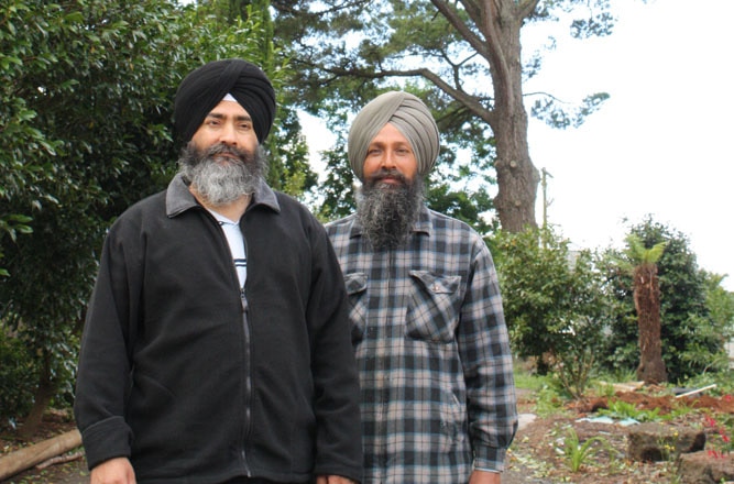 Charnamat Singh (left), at his farm at Kinglake, Victoria