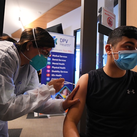 Healthcare worker Simi Kandra (left) administers a Covid19 vaccine for Omar Khodr at a pop-up Covid19 vaccination clinic in Broadmeadows, Melbourne.