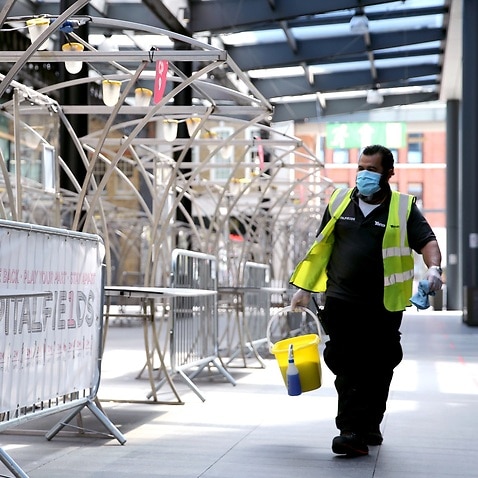A cleaner walks through Spitalfields Market in East London, as the market has rearranged its stalls layout to respect social distance guidelines, as the government begins easing some lockdown measures in England. Picture date: Monday June 1, 2020..