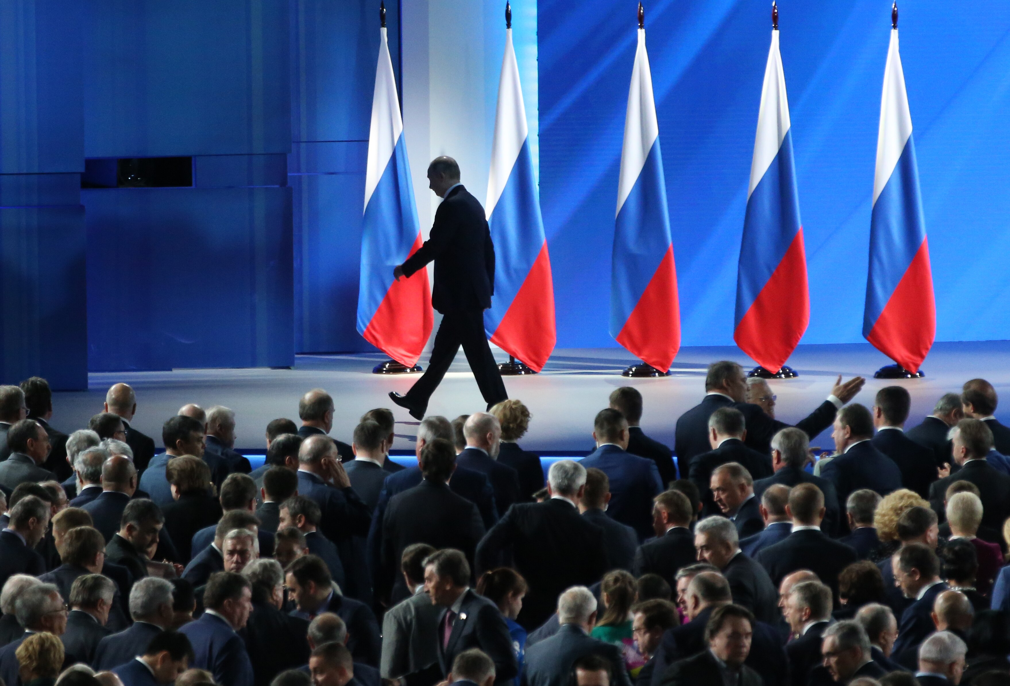 Mr Putin walks out following his national address.