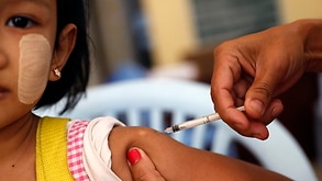 A medical worker of Myanmar public health department inoculates a girl for measles and rubella during a nationwide vaccination campaign