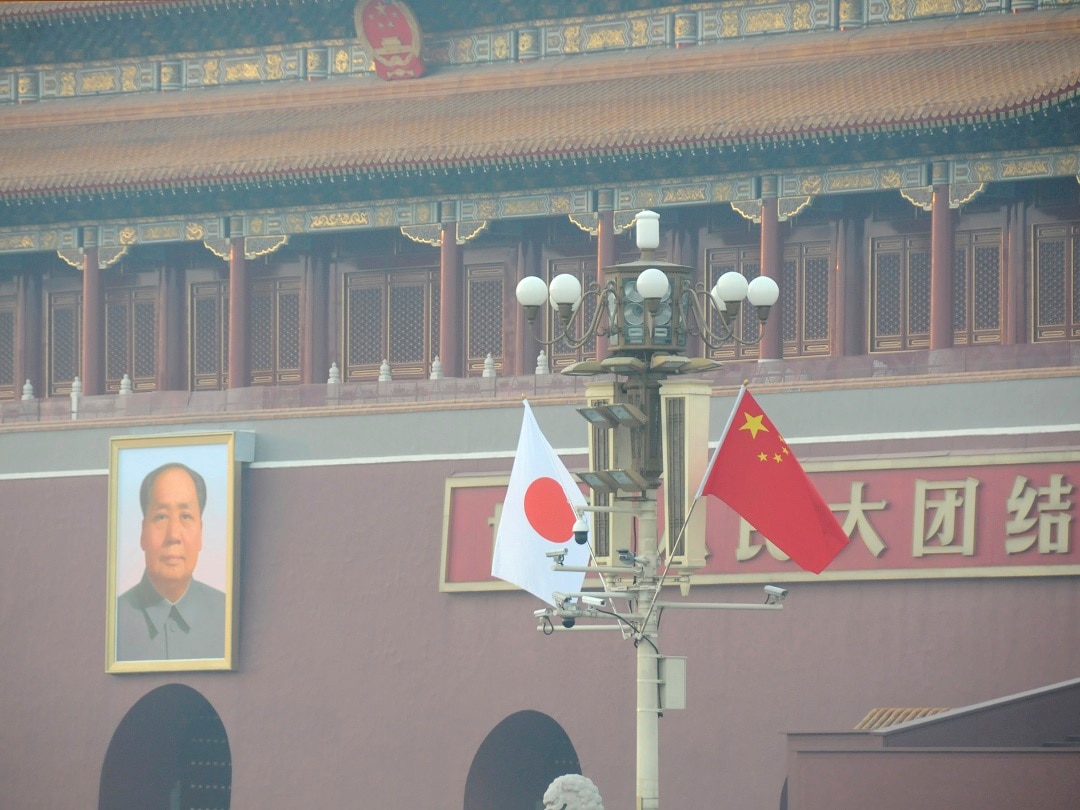 Chinese and Japanese national flags flutter on the lamppost in front of the Tiananmen during the three-day official visit.