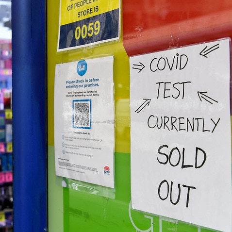 Signage notifying customers that Rapid Antigen Test  kits are sold out is seen on the entrance to a chemist in Sydney, Tuesday, 11 January, 2022.
