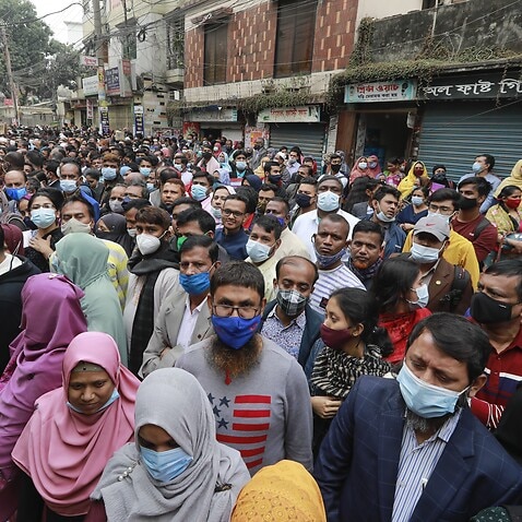 Parents gather shoulder to shoulder outside Holy Cross School admission tests amid a record surge in coronavirus infection, in Dhaka, Bangladesh, January 14, 2022. 
