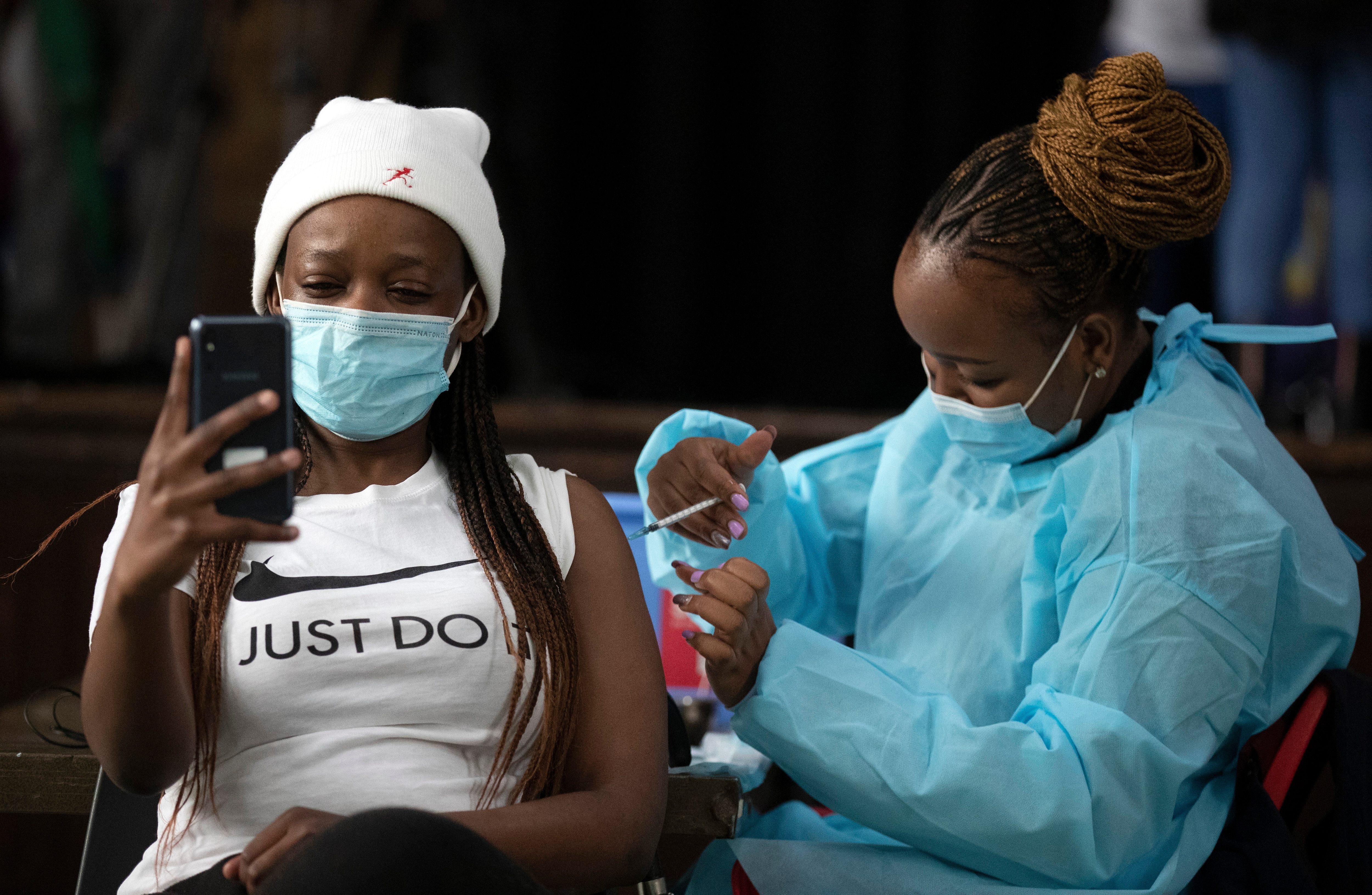 A healthcare worker administers the Pfizer COVID-19 vaccine from to a woman in Katlehong, east of Johannesburg, South Africa.