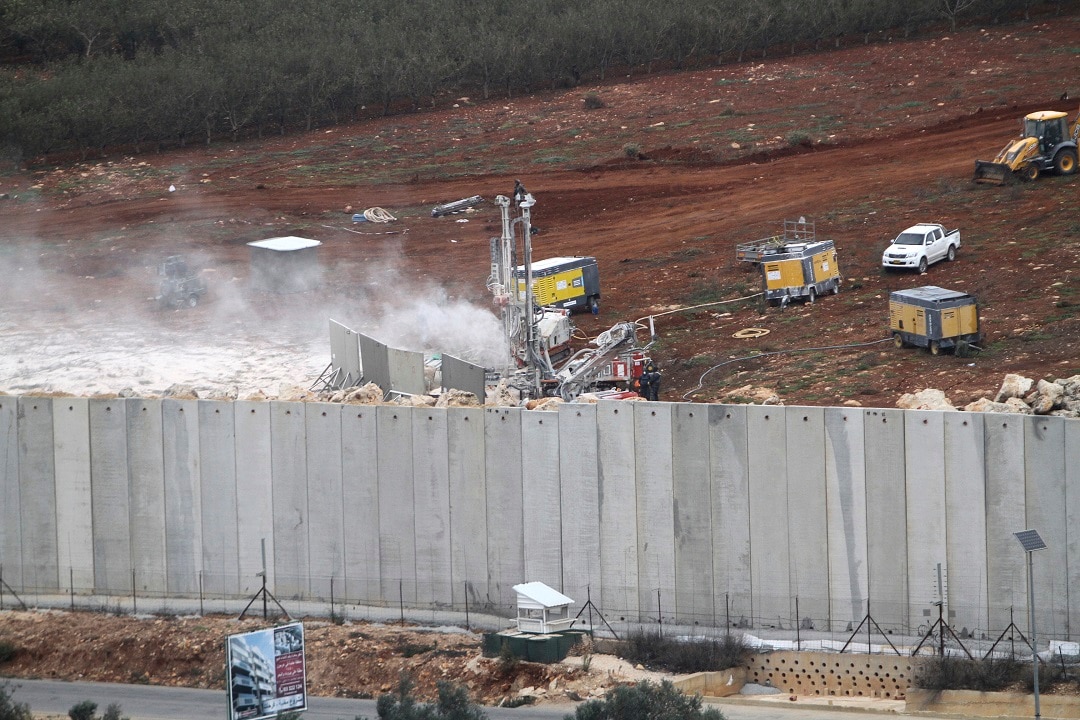 An Israeli military digger destroys the Lebanese-Israeli border.