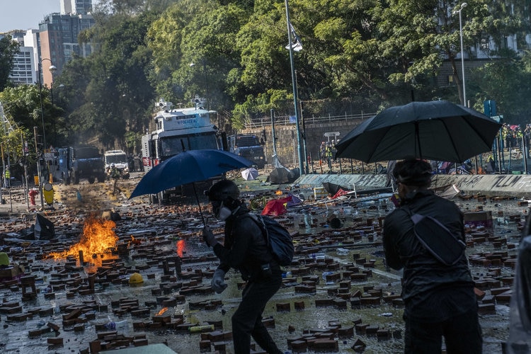 Police rush barricades at the university campus. Hong Kong Protests: Police Rush Barricades at University Campus, but Retreat in Face of Fire