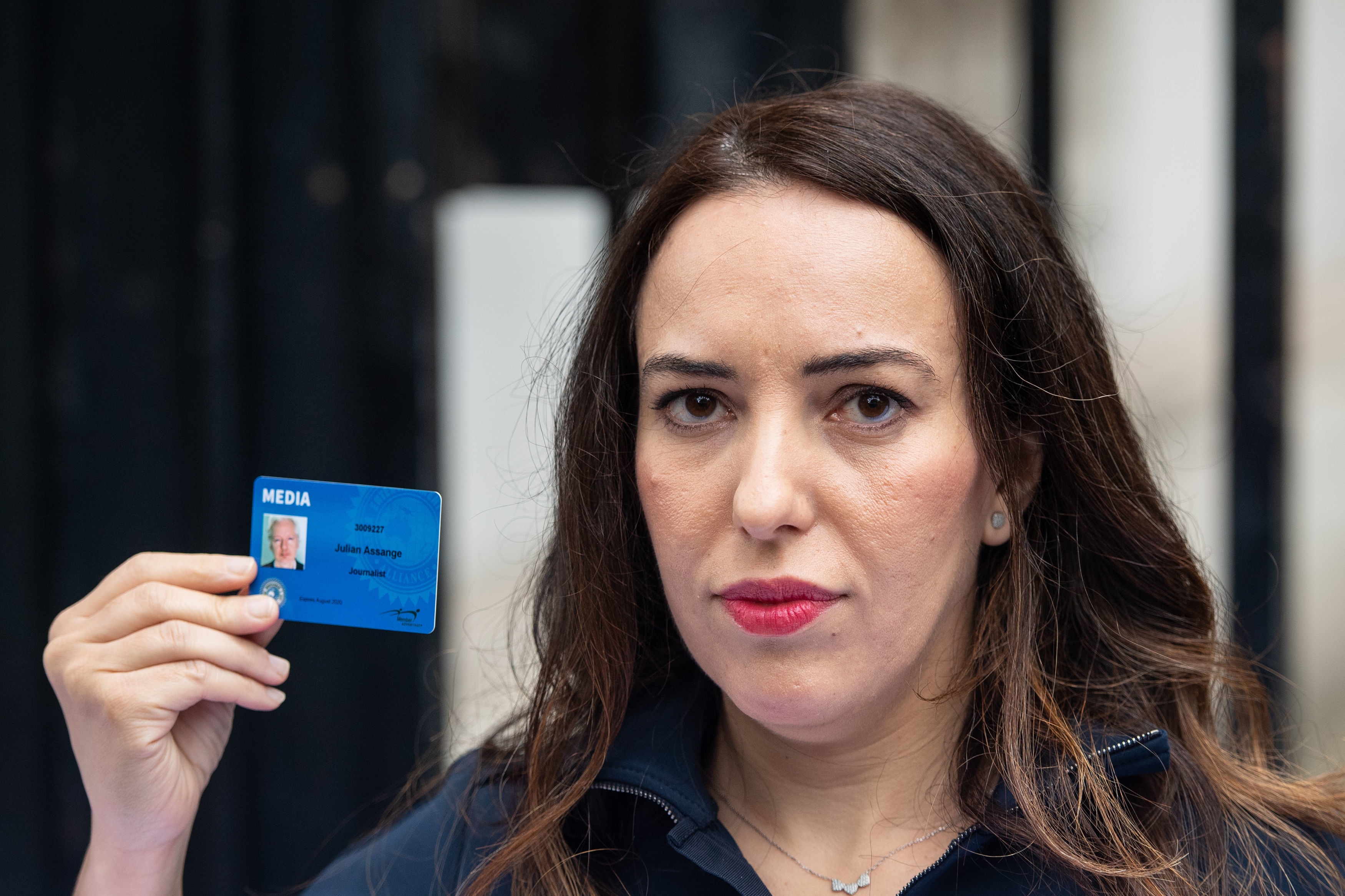 Stella Moris holds up a Julian Assange press card after attempting to deliver a Reporters Without Borders petition against the extradition of her partner.