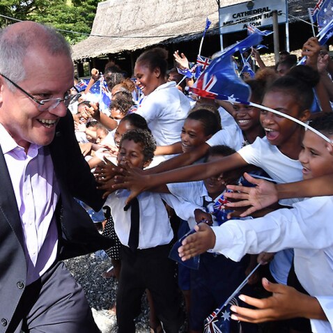 Australian Prime Minister Scott Morrison is seen with children at St Barnabas Anglican Cathedral in Honiara in the Solomon Islands, on Monday, June 3, 2019. 