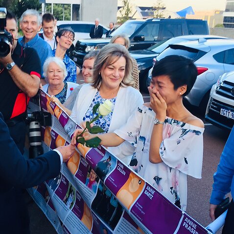 WA Premier Mark McGowan hands a white rose to assisted dying supporter Belinda Teh