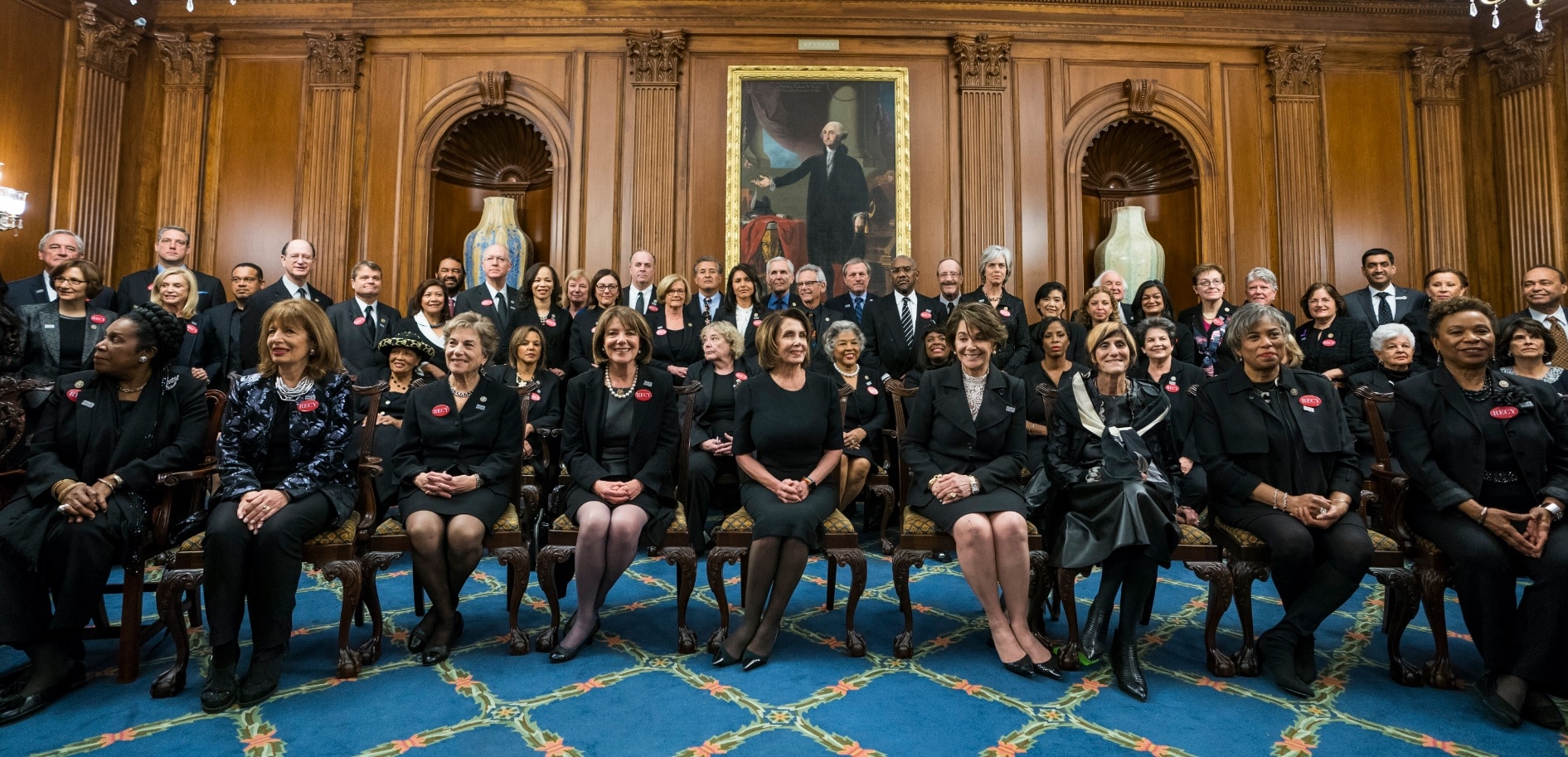 Democratic House Minority Leader Nancy Pelosi (C), along with Democratic members of a House and Senate, poise for photographs while wearing black (AAP)