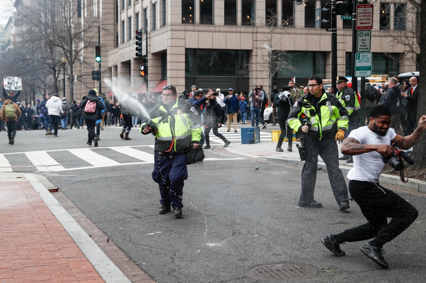 Police officers fire pepper spray at protesters during a demonstration after the inauguration of President Donald Trump (AAP) Police officers fire pepper spray at protesters during a demonstration after the inauguration of President Donald Trump, Friday, Jan. 20, 2017, in Washington.