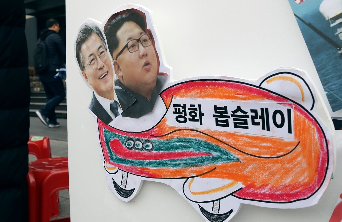 Pictures of South Korean President Moon Jae-in and North Korean leader Kim Jong-Un on a sign during a rally to denounce the US policy towards the north.