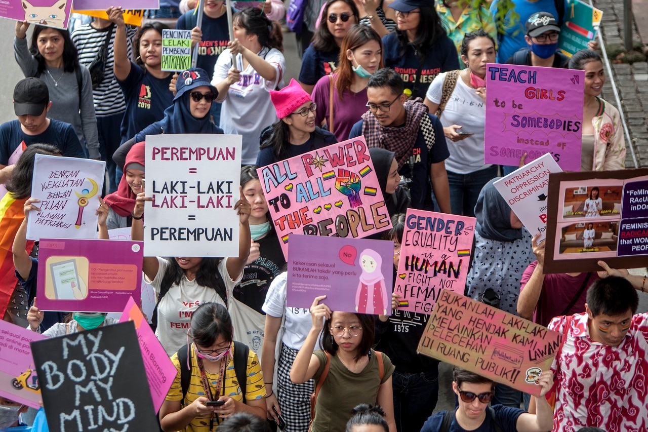 Protesters walk during a Women's March in Jakarta.