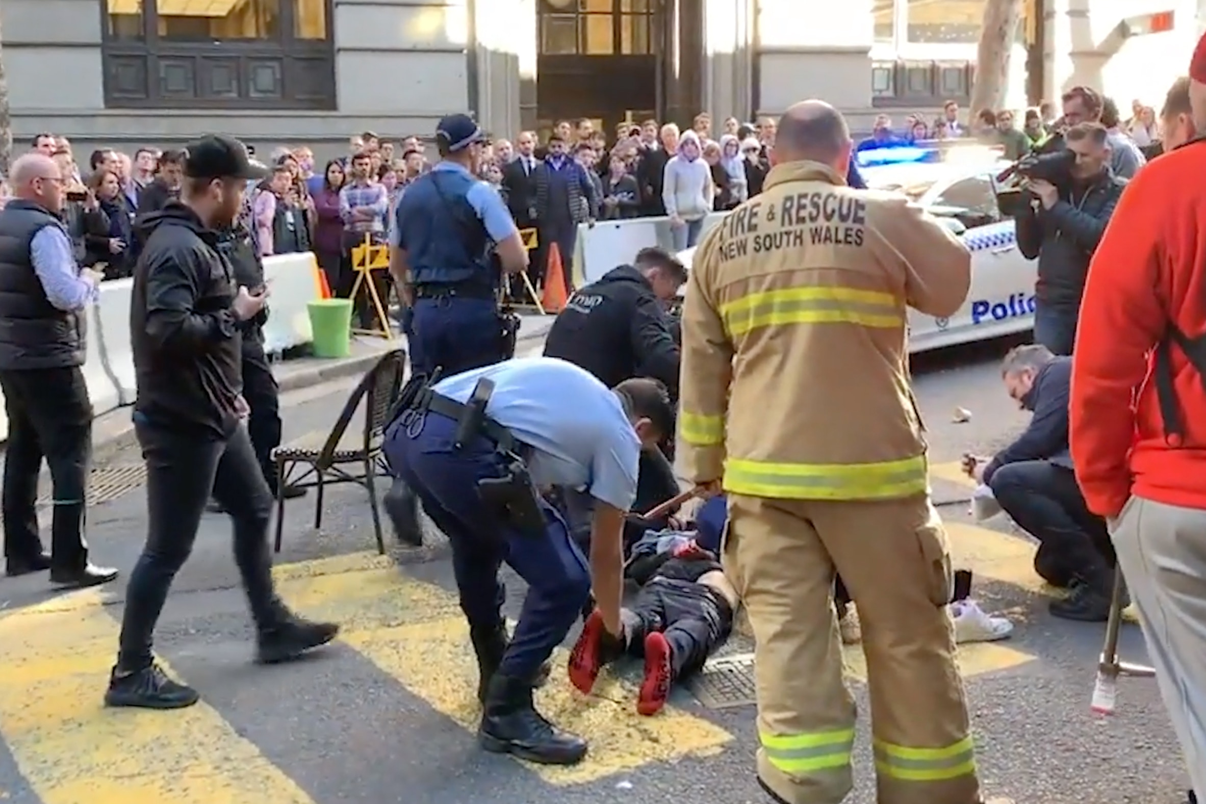 An image obtained from video on Tuesday, August 13, 2019, shows a man being arrested after a woman was stabbed in Sydney's CBD. 