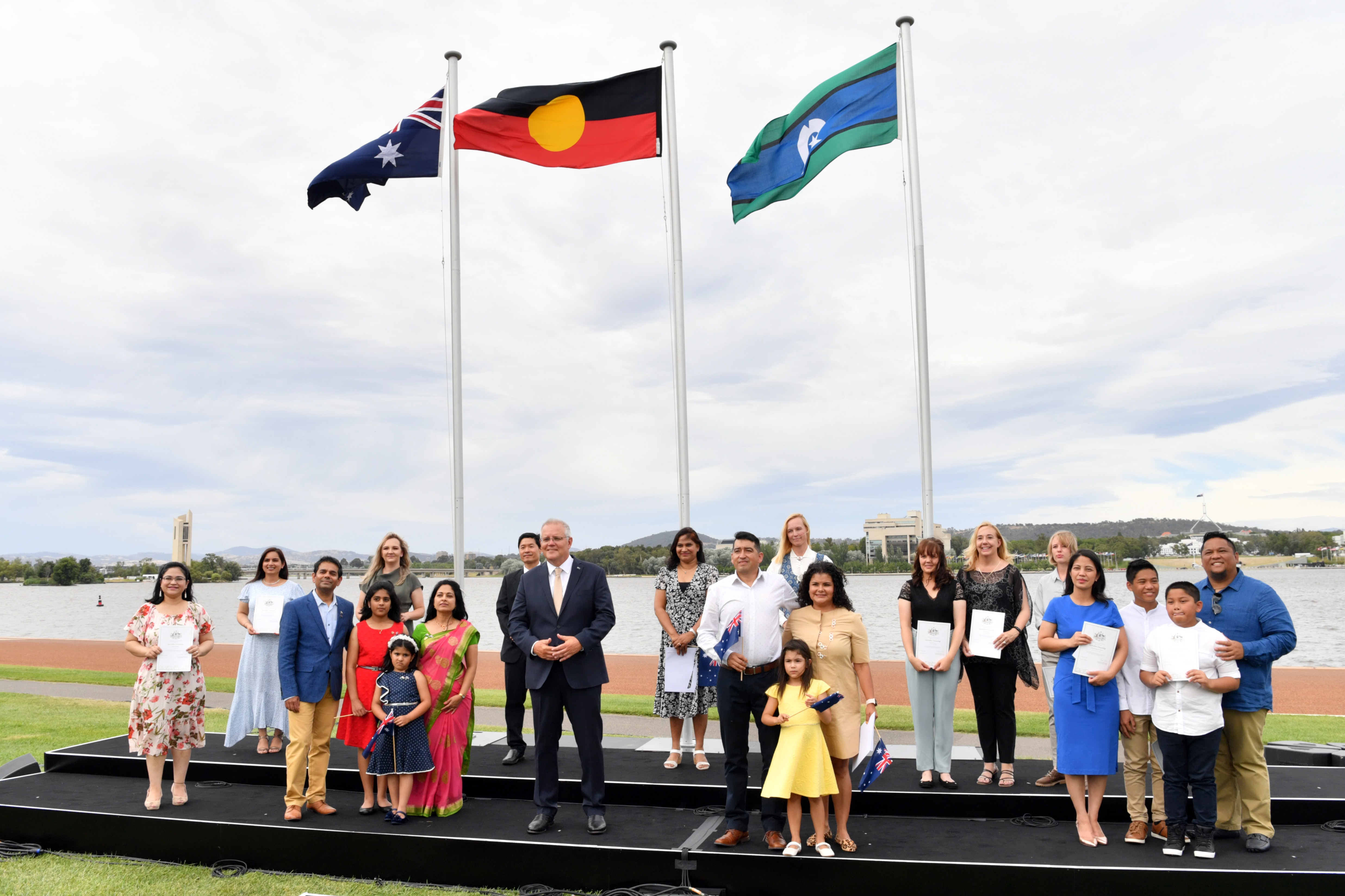 Prime Minister Scott Morrison poses for a photo with new citizens during an Australia Day Citizenship Ceremony and Flag Raising event in Canberra.