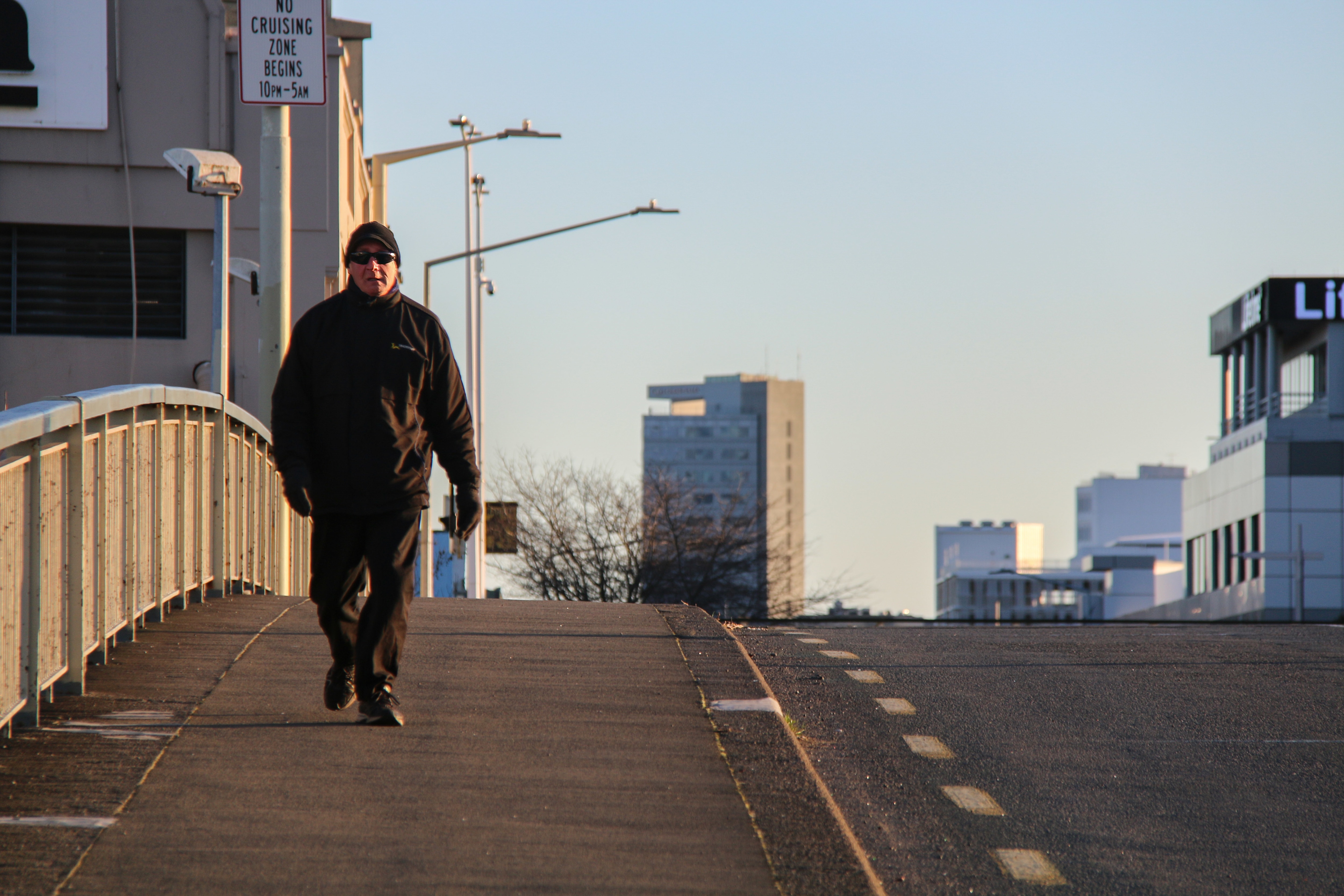 A man in Christchurch doing some early morning exercise on an empty street.