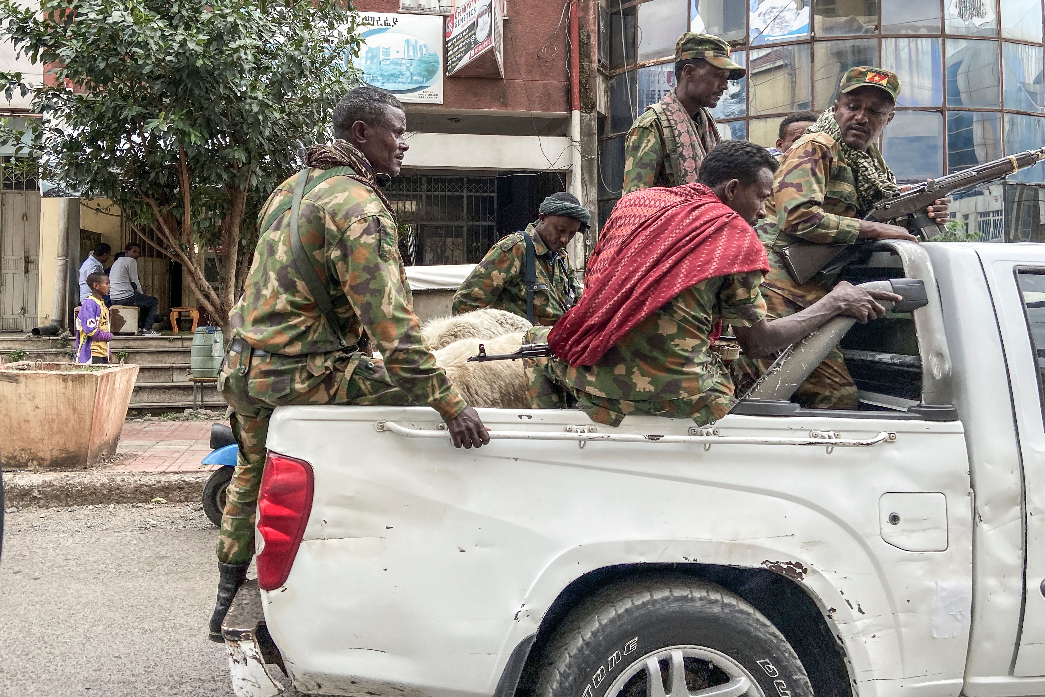 Members of the Amhara militia, that fight alongside federal and regional forces against northern region of Tigray, ride on the back of a pick up truck