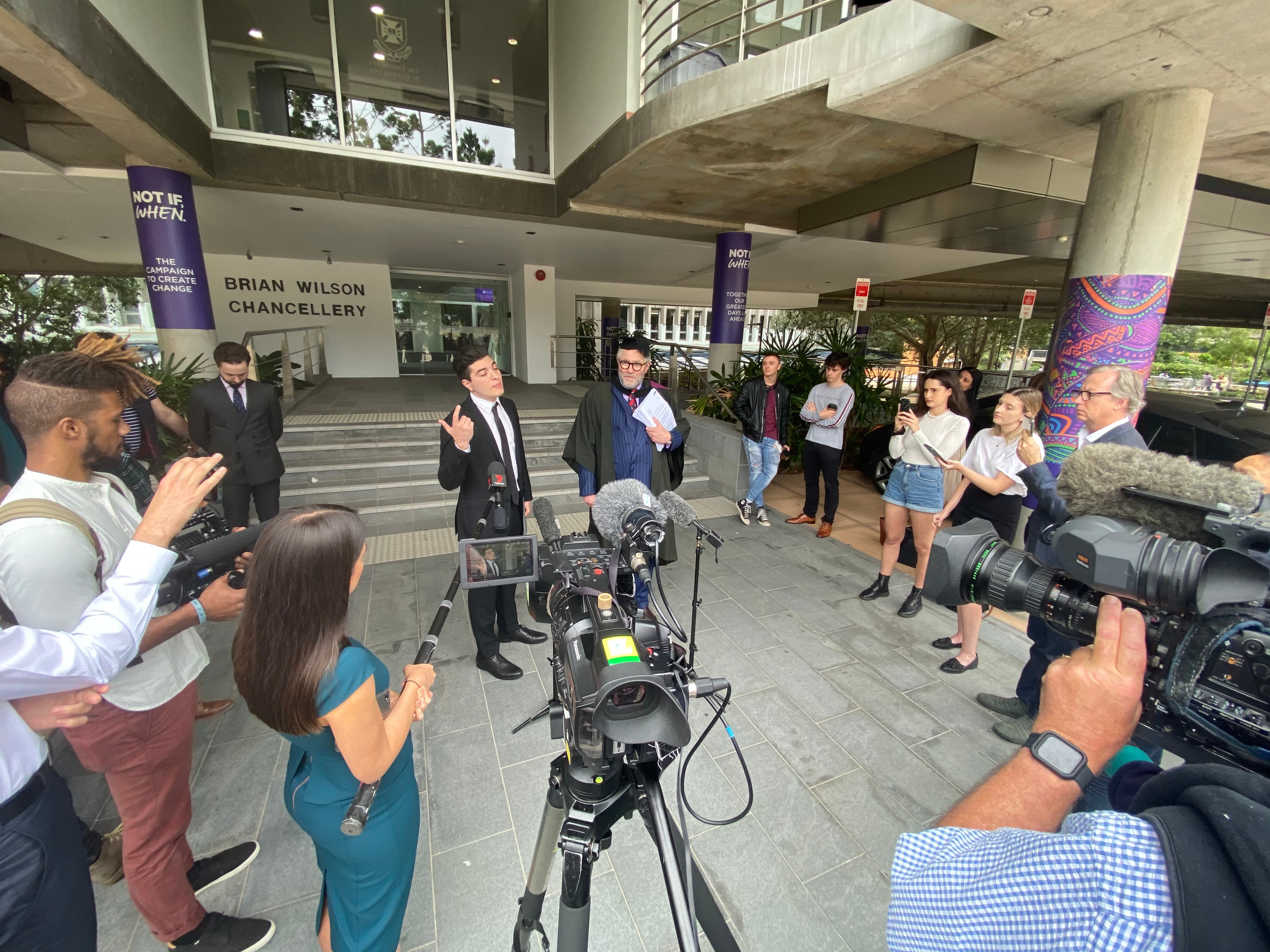 Student Drew Pavlou and barrister Tony Morris address the media outside UQ disciplinary hearing.