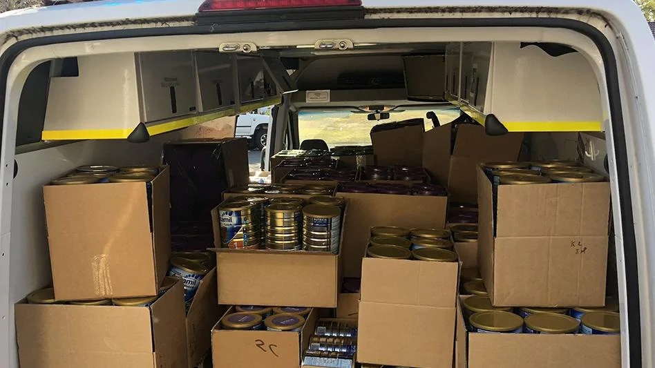 Thousands of baby formula tins seized by police