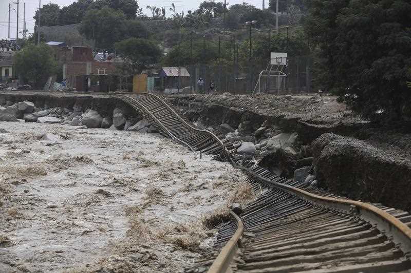 Train tracks lay destroyed in a flooded river in the Chosica district of Lima, Peru, Sunday, March 19, 2017.