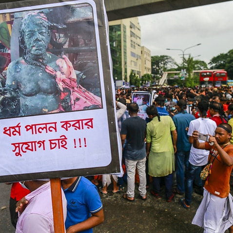 Dhaka University students and ISKCON members hold a demonstration at Shahbagh to protest attacks on Hindu temples and puja venues across Bangladesh.