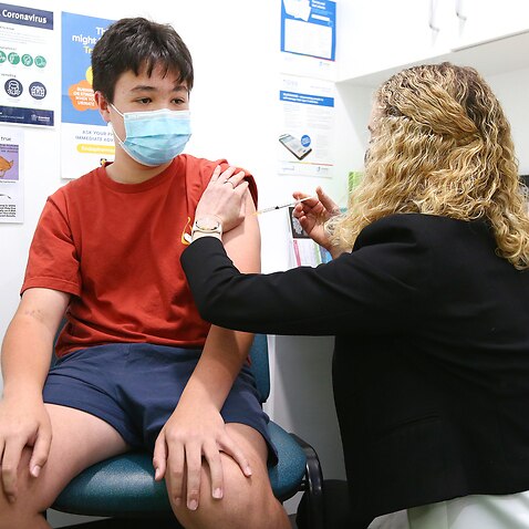 Campbell Park, 12, receives his first dose of the Moderna COVID-19 vaccination at Priceline Pharmacy in Brisbane, Wednesday, September 22, 2021. (AAP Image/Jono Searle) NO ARCHIVING