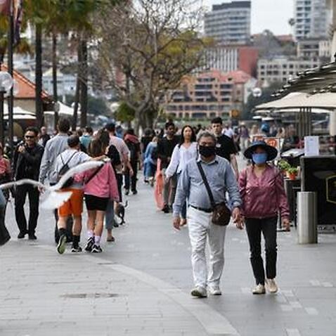 People wear face masks in Circular Quay in Sydney, Australia. 