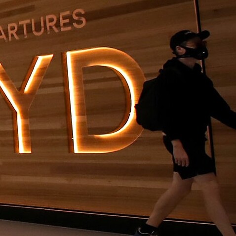 A passenger walks at the departure area of Sydney Airport, in Sydney, Australia, March 18, 2020.  