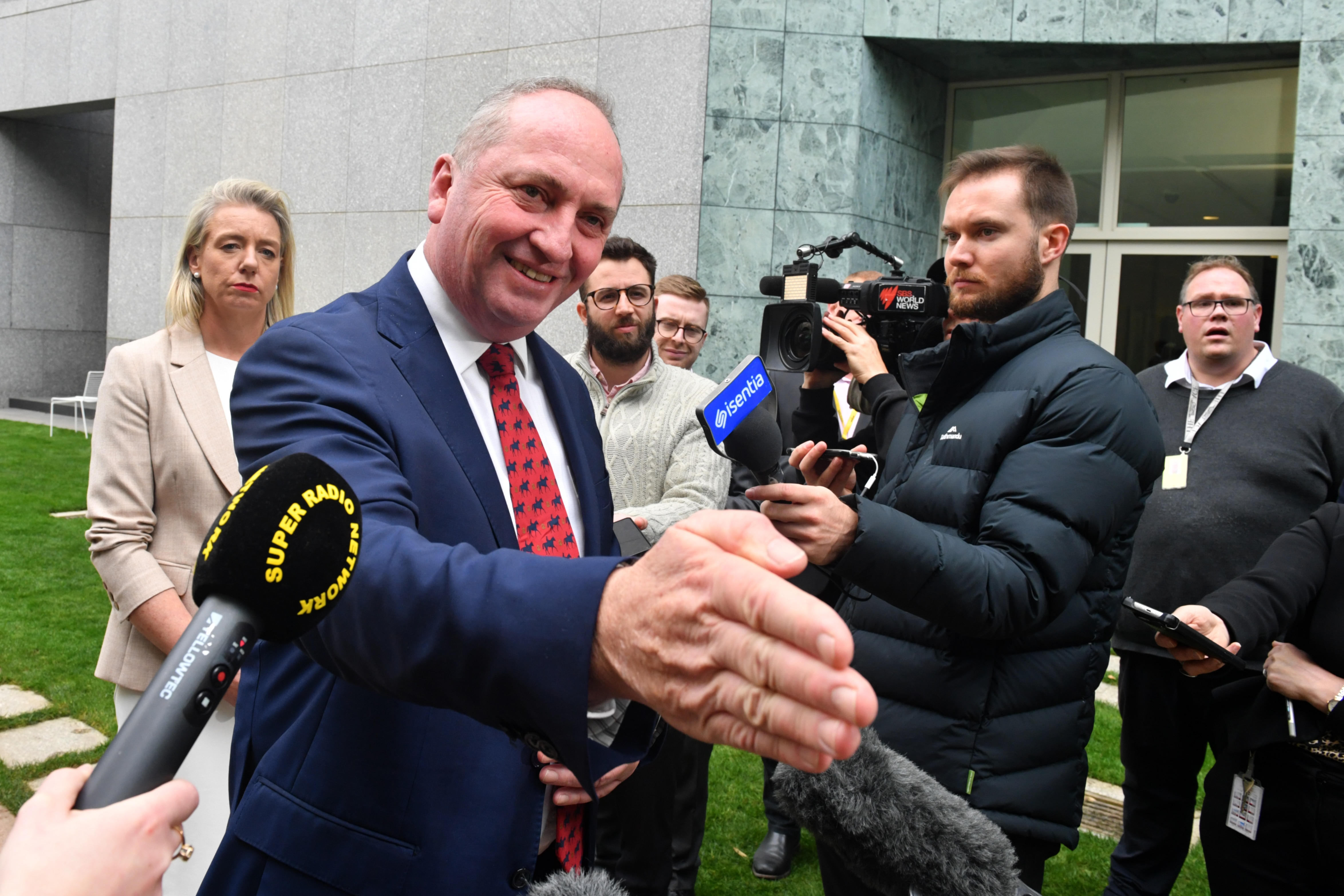 Barnaby Joyce and Senator Bridget McKenzie arrive at a press conference after the Nationals party room meeting.