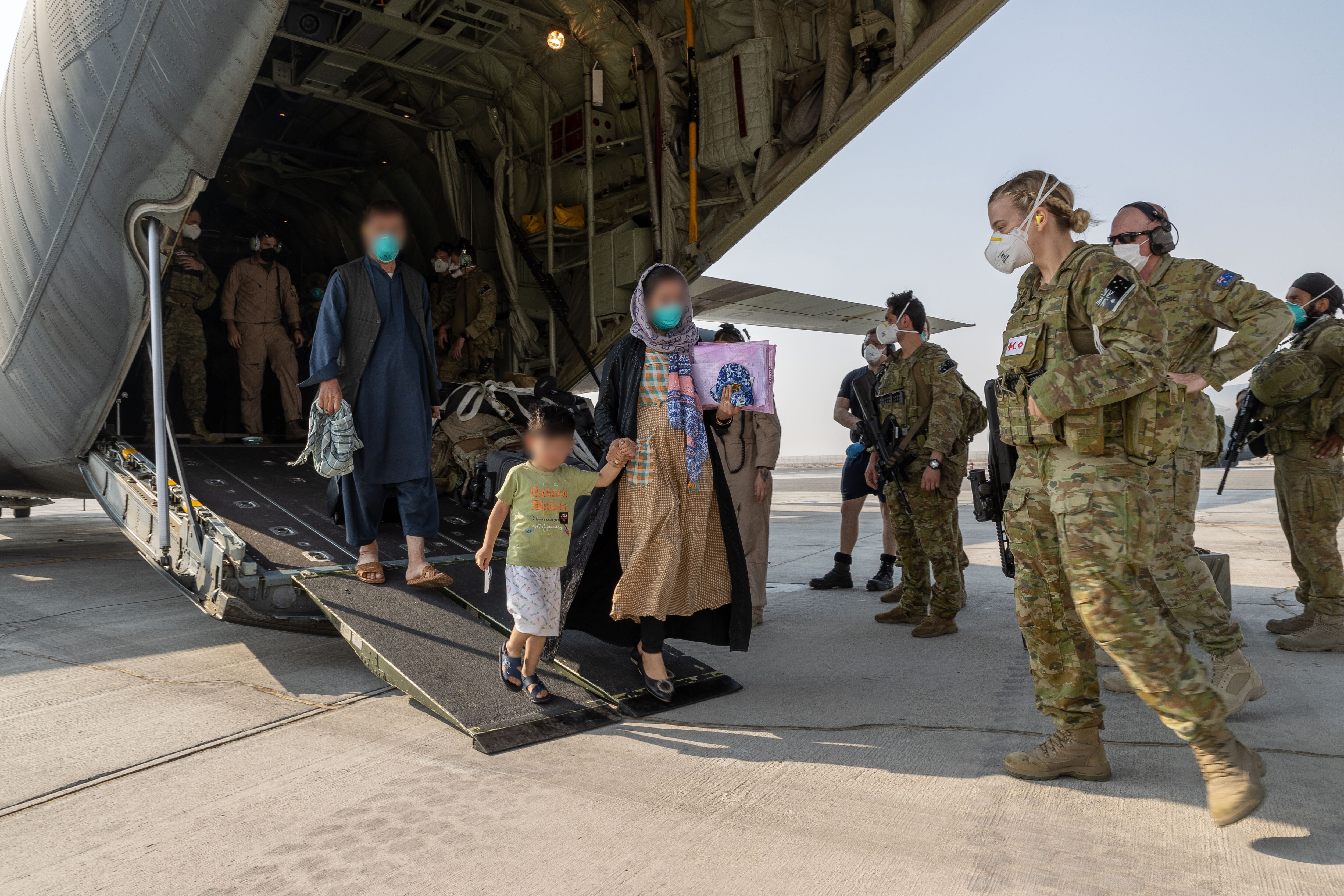 Afghanistan evacuees and soldiers from the Australian Defence Force at Kabul airport on 27 August 2021.