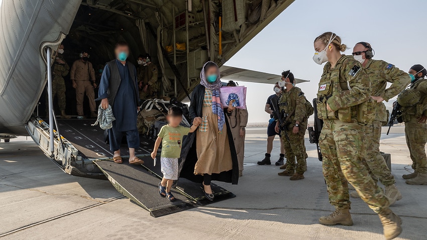 Afghanistan evacuees and soldiers from the Australian Defence Force at Kabul airport on 27 August 2021.