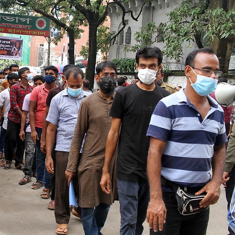 Expatriate workers are wait in a queue for the COVID-19 vaccine at Dhaka Medical hospital in Dhaka, Bangladesh on August 6, 2021. (Photo by Abu Sufian Jewel/Medialys Images/Sipa USA)