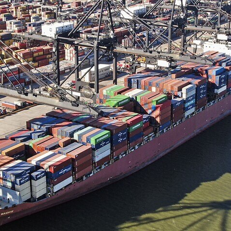 An aerial photo made with a drone shows a ship being loaded with containers at a Port of Houston facility in La Porte, Texas, USA, 29 October 2021.