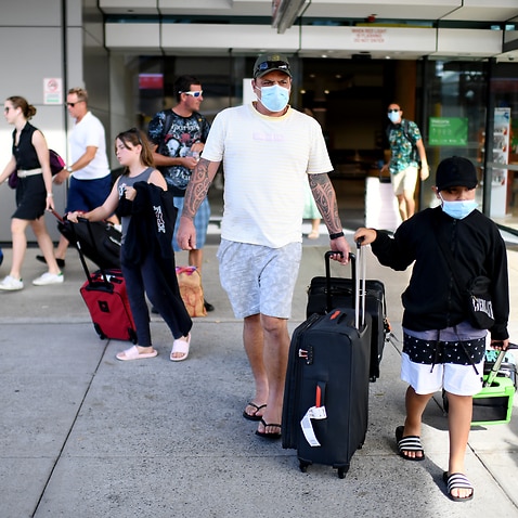 Passengers wearing face masks as they exit the domestic terminal in Brisbane airport.