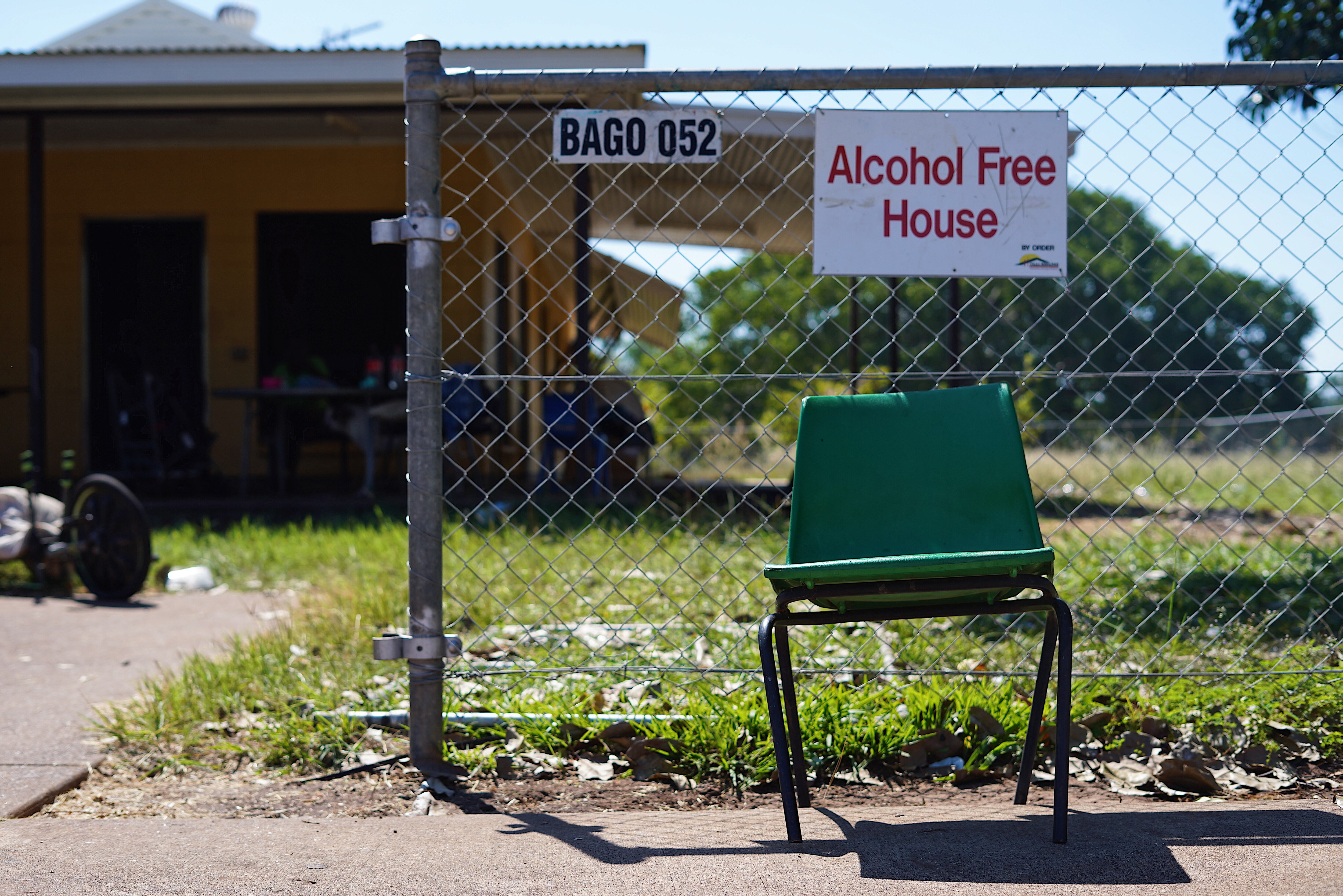 chair in front of home with alcohol free house sign 