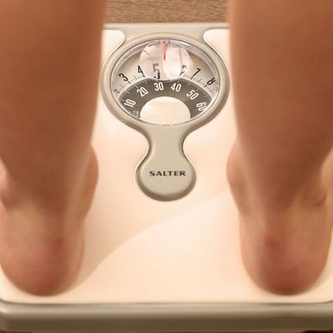  photo dated 03/03/14 of a child using a set of weighing scales